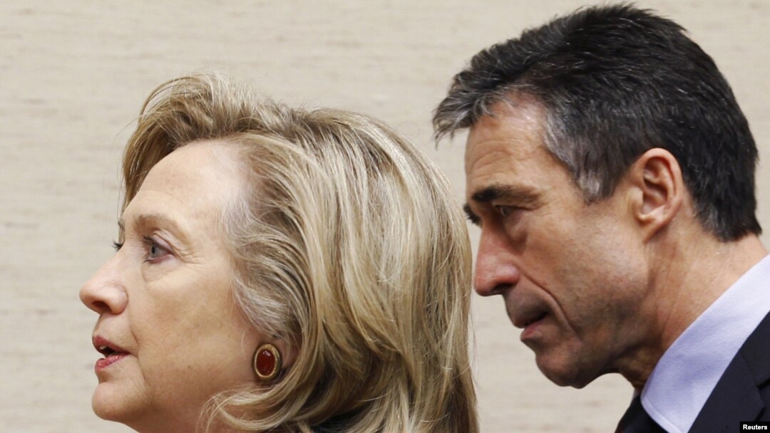 U.S. Secretary of State Hillary Clinton (left) and NATO Secretary-General Anders Fogh Rasmussen arrive at a NATO defense and foreign ministers' meeting at alliance headquarters in Brussels.