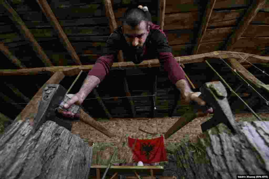Gymnastics trainer Mirland Gashi, 27, exercises with self-built tools at his home during COVID-19 disease pandemic, in the western Kosovo village of Isniq. (epa-EFE/Valdrin Xhemaj)