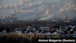 Smoke rises from an oil refinery behind the city of Omsk, Russia. European countries have been cutting their dependence on Russian oil following the country's unprovoked, large-scale invasion of Ukraine in February 2022. 