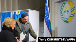 People voting at a polling station in Tashkent on December 22.