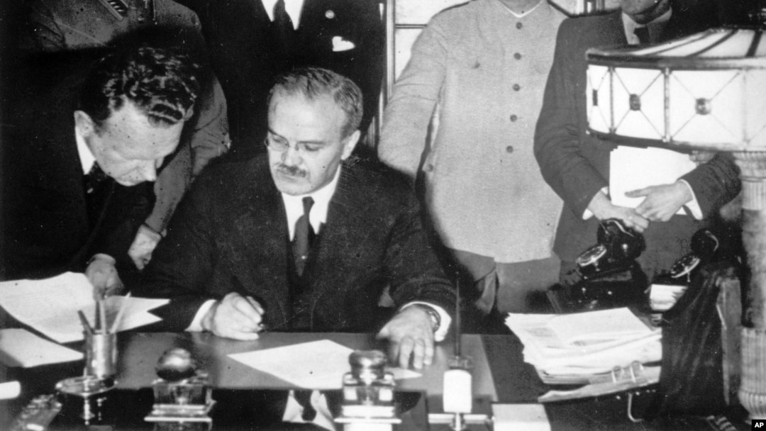 Soviet Foreign Minister Vyacheslav Molotov (seated) signs the German-Soviet non-aggression pact in Moscow on August 23. 