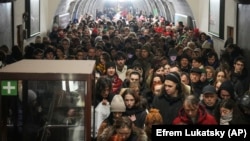 People take shelter in a metro station during an air raid alarm in Kyiv on December 20. 