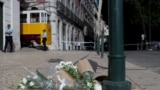Flowers in tribute to the victims are pictured on the site of the Gloria funicular railway the day after the accident that left 15 dead in Lisbon, on September 4, 2025.