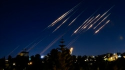 Missiles fired from Iran are pictured in the night sky over Jerusalem on June 14.