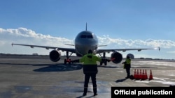 Armenia - Marshallers guide a plane that landed at Zvartnots international airport, Yerevan, January 15, 2021.