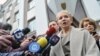 Former Prime Minister Yulia Tymoshenko speaks to the media in front of the prosecutor's office after her interrogation. She and other former members of her cabinet have faced charges they say are politically motivated.