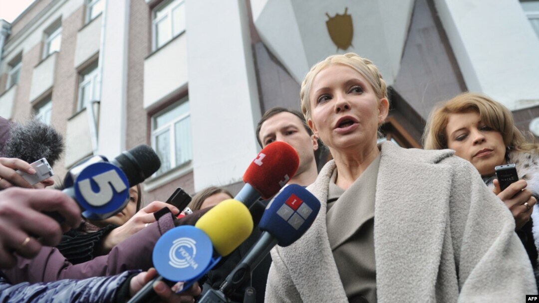 Former Prime Minister Yulia Tymoshenko speaks to the media in front of the prosecutor's office after her interrogation. She and other former members of her cabinet have faced charges they say are politically motivated.