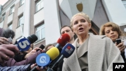 Former Prime Minister Yulia Tymoshenko speaks to the media in front of the prosecutor's office after her interrogation. She and other former members of her cabinet have faced charges they say are politically motivated.