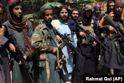 Taliban fighters pose in central Kabul on August 18.