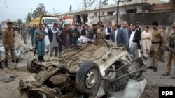 Afghan officials inspect the scene of a suicide bomb attack in Lashkar Gah, capital of Helmand province on March 19.