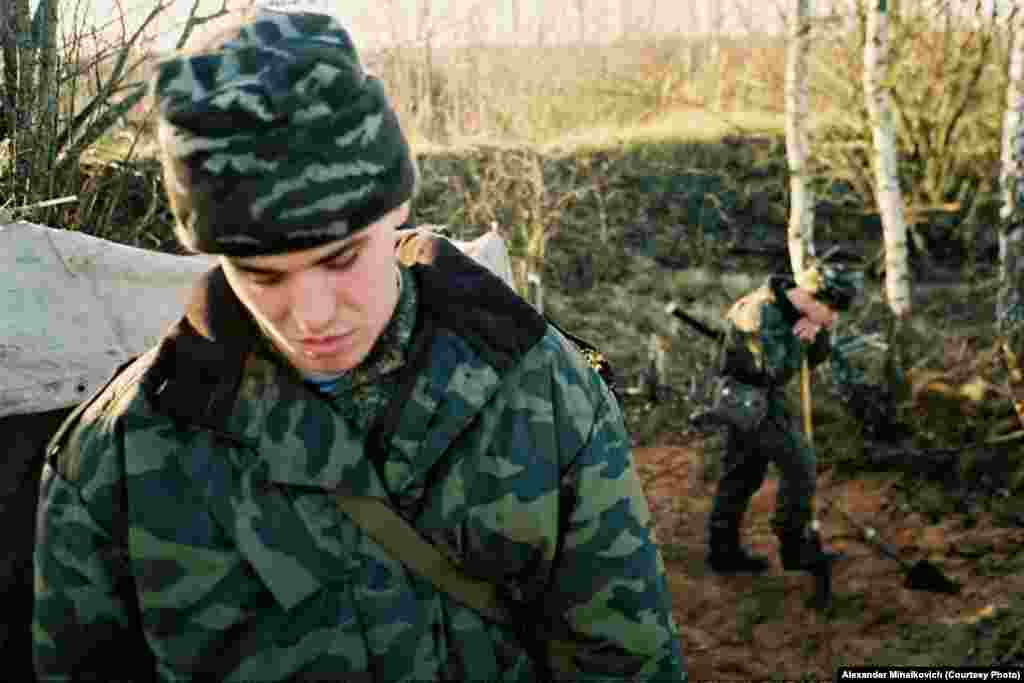 A recruit digs a hole for the officers&#39; latrine.