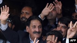 Iftikhar Muhammad Chaudhry (left) waves to supporters at his residence in Islamabad after his reinstatement was announced