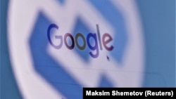 The logo of Russia's state communications regulator, Roskomnadzor, is reflected in a laptop screen showing the Google start page.