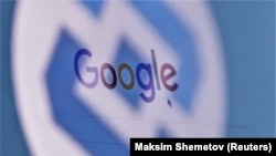 The logo of Russia's state communications regulator Roskomnadzor is reflected in a laptop screen showing Google's start page.