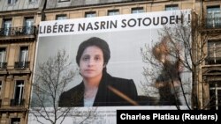 FRANCE -- A banner with a giant portrait of jailed Iranian lawyer Nasrin Sotoudeh is seen on the headquarters of the French National Bar Council, demanding her release, in Paris, March 28, 2019