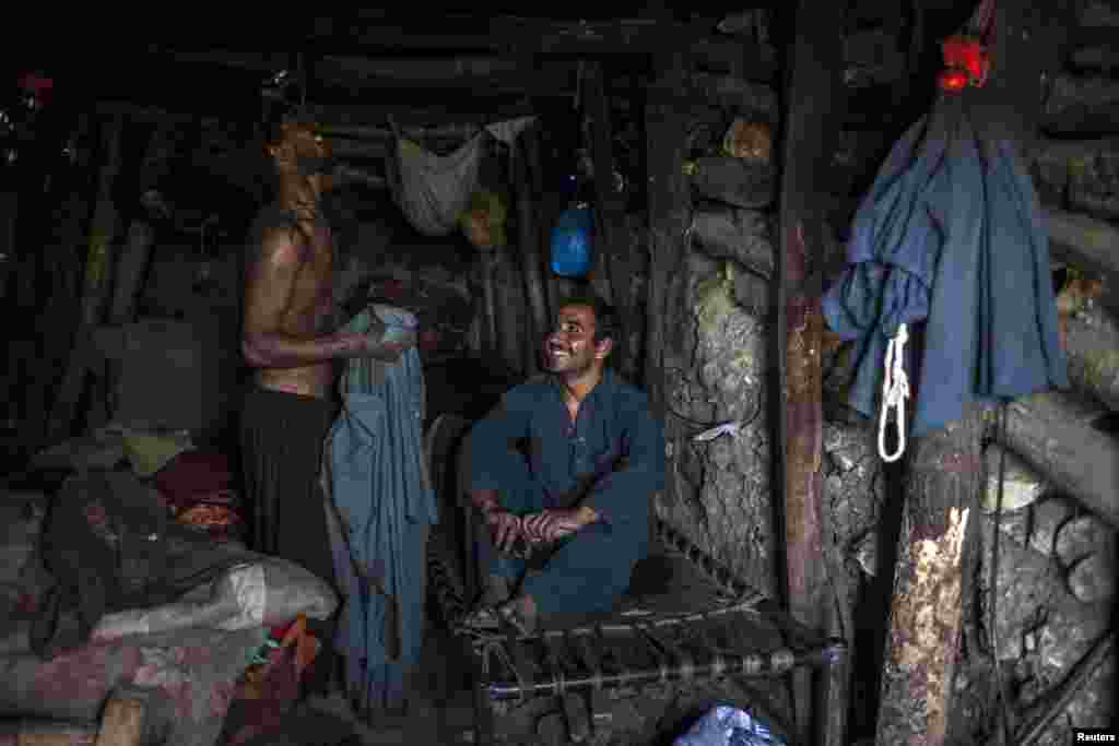 Miners rest in an underground room at the end of a workday.