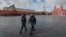 RUSSIA -- Police officers wearing protective masks walk on deserted Red Square in front of the Kremlin in Moscow, April 17, 2020