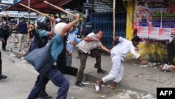 Bangladeshi police baton-charge demonstrators during the clashes in Dhaka on May 5. 