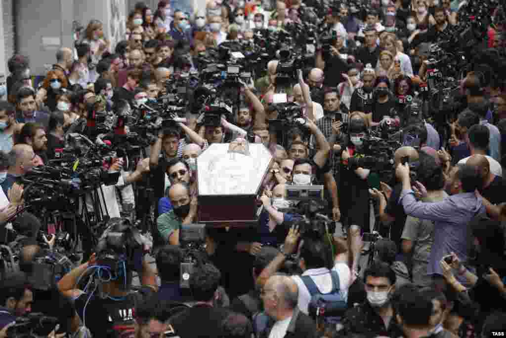 The open coffin of Georgian TV cameraman Lekso Lashkarava is carried through the streets of Tbilisi on July 13 during his funeral. He was&nbsp;found dead at home on July 11, days after being attacked by an anti-LGBT mob while covering the Tbilisi Pride parade.