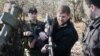 RUSSIA -- CHECHNYA,RUSSIA. November 25, 2003. Chief of the Chechen President's Security Service Ramazan Kadyrov (Center) handles a sniper rifle which is able to hit a target at the range of 2.5 kilometers. The rifle was found in a large arms cache in the 