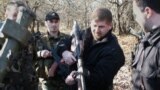 RUSSIA -- CHECHNYA,RUSSIA. November 25, 2003. Chief of the Chechen President's Security Service Ramazan Kadyrov (Center) handles a sniper rifle which is able to hit a target at the range of 2.5 kilometers. The rifle was found in a large arms cache in the 