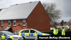 British police officers guard the home of former Russian intelligence officer Sergei Skripal in Salisbury. 