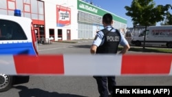 A policeman stands near a cordoned off area next to the Club Grey disco where a deadly shooting incident occurred in the southern German town of Konstanz on July 30. 