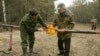 A 2006 file photo of workers fixing a radiation warning sign near the village of Babchin, Belarus 