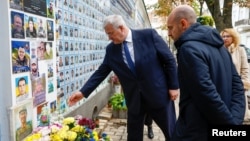 French Minister for Europe and Foreign Affairs Jean-Noel Barrot (right) and Ukrainian Foreign Minister Andriy Sybiha visit the Memory Wall of Fallen Defenders of Ukraine outside St. Michael's Cathedral in Kyiv on October 19.