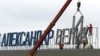 Workers dismantle the "Alexander the Great" sign at Macedonia's Skopje airport on February 24. 