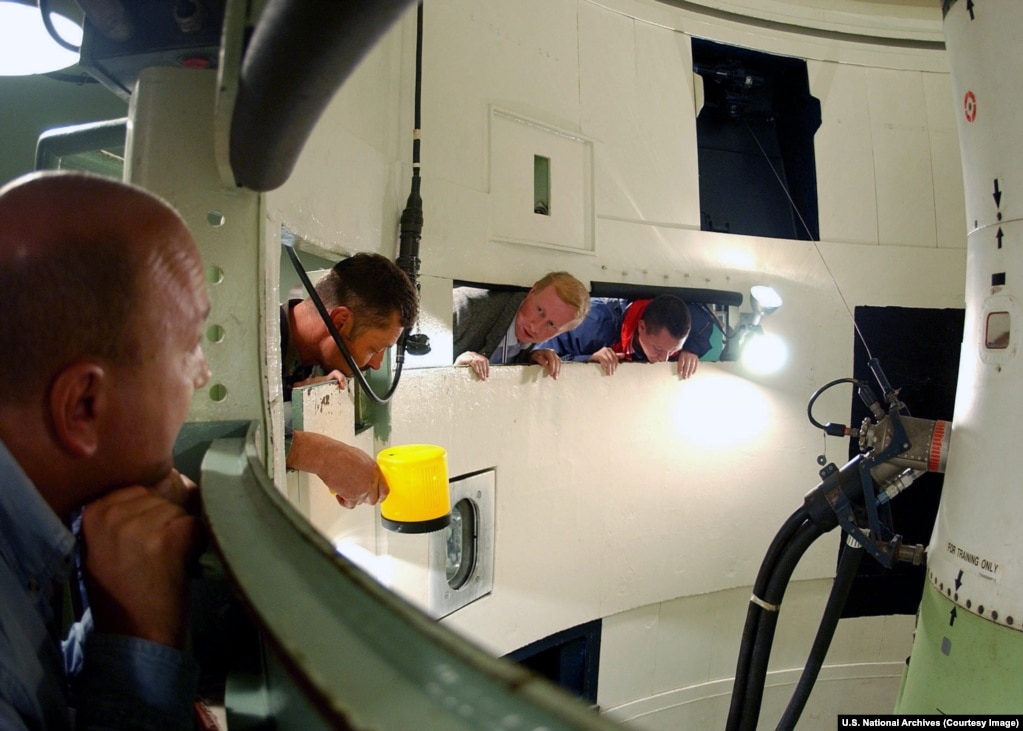 Russian and U.S. inspection teams look into a U.S. Air Force Minuteman II training silo as part of the Strategic Arms Reduction Treaty (START) in South Dakota.