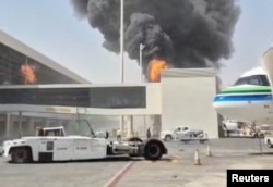 Smoke and flames rise from King Khalid Airport, after Yemen's Iran-backed Houthis said they attacked the airport, in Riyadh, Saudi Arabia, October 8.