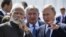 Russia's Vladimir Putin (right) speaks with India's Narendra Modi during a visit to the Zvezda shipyard, as Rosneft chief Igor Sechin (center) looks on, outside Vladivostok on September 4.