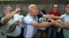 Armenia -- Opposition lawmaker Hrant Bagratian (L) clashes with a protester (R) outside the parliament building in Yerevan, 27June, 2016 