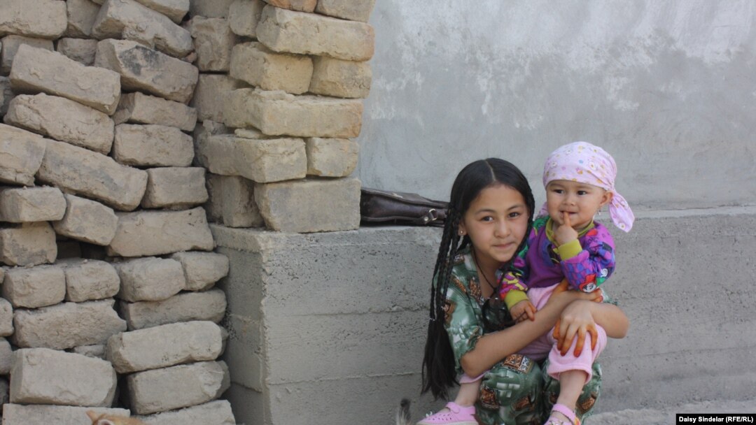 Ten-year-old Madina, an ethnic Uzbek, holds her niece in the courtyard of her family home in an Uzbek mahalla in the southern Kyrgyz city of Osh. Her family’s home was destroyed by fire in the June 2010 ethnic clashes.