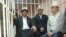 Opposition deputies Kamchybek Tashiev, Sadyr Japarov, and Talant Mamytov (left to right) in the dock at the start of their trial in Bishkek on January 10.