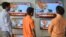 Indian men watch a live broadcast of Indian Prime Minister Narendra Modi on televisions displayed in an electronic store, in Amritsar on March 27.