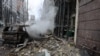 Smoke billows from a burned-out car following Russian missile strikes on Kyiv on December 20. 