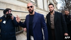 Andrew Tate (center) and Tristan Tate (second right) leave a courthouse in Bucharest on December 22, 2023.