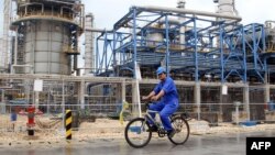 A worker rides a bicycle through the Nouri Petrochemical facilities of the South Pars gas field, which the planned pipeline would link with consumers in South Asia.