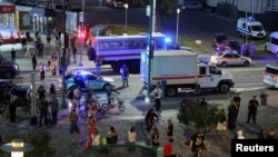 Law enforcement officers and emergency services personnel near the site of an explosion at a restaurant in central Moscow, Russia, on August 1.