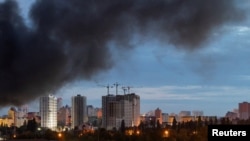 Smoke rises above Kyiv on July 11 following a Russian strike, with authorities saying ultra-fast ballistic missiles overwhelmed air defenses.