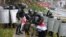Riot police detain protesters carrying the red-and-white flag of the Belarusian opposition on November 8 in Minsk.