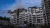 Smoke billows from a residential building following explosions in Kyiv on June 26. Several explosions rocked the west of the Ukrainian capital in the early hours, with at least two residential buildings struck, according to Kyiv Mayor Vitali Klitschko.