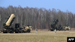 US troops from the 5th Battalion of the 7th Air Defense Regiment emplace a launch station of the Patriot air and missile defence system at a test range in Sochaczew, March 21, 2015