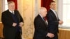 Greek Foreign Minister Nikos Kotzias (left), UN envoy Matthew Nimetz (center), and Macedonian Foreign Minister Nikola Dimitrov arrive for talks in Vienna on March 30.