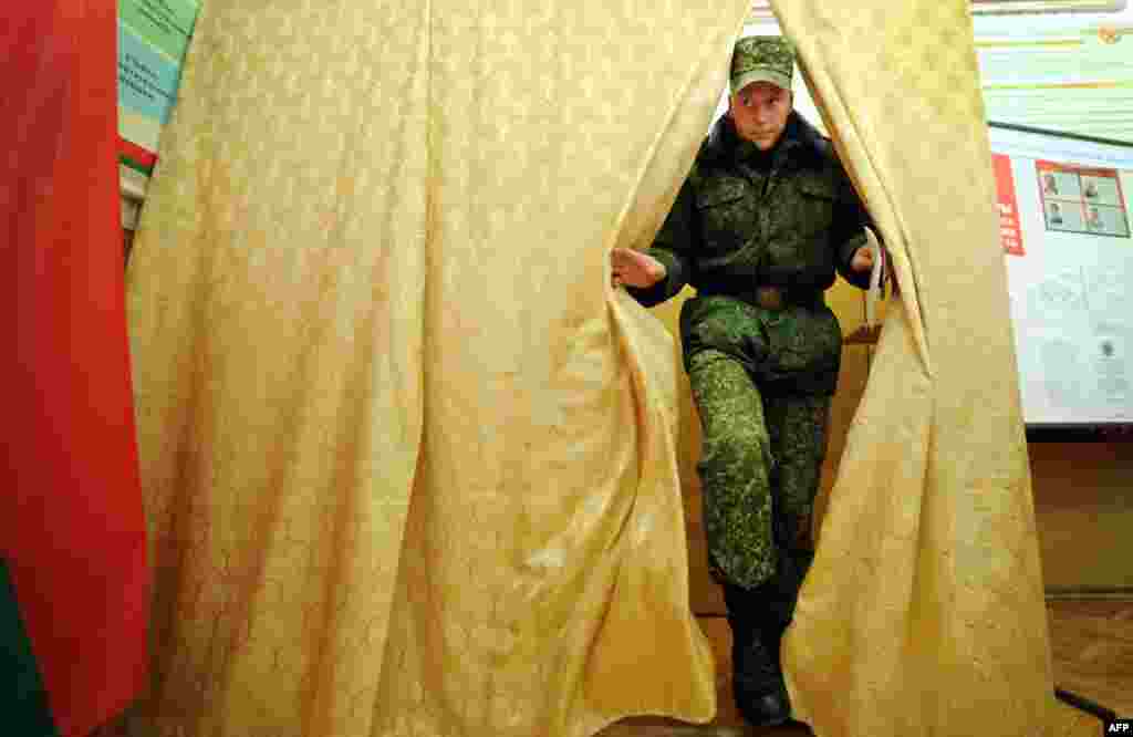 A Belarusian military cadet leaves a polling booth after casting his ballot during early voting for the country&#39;s presidential election in Minsk on October 7. (AFP/Sergei Gapon)