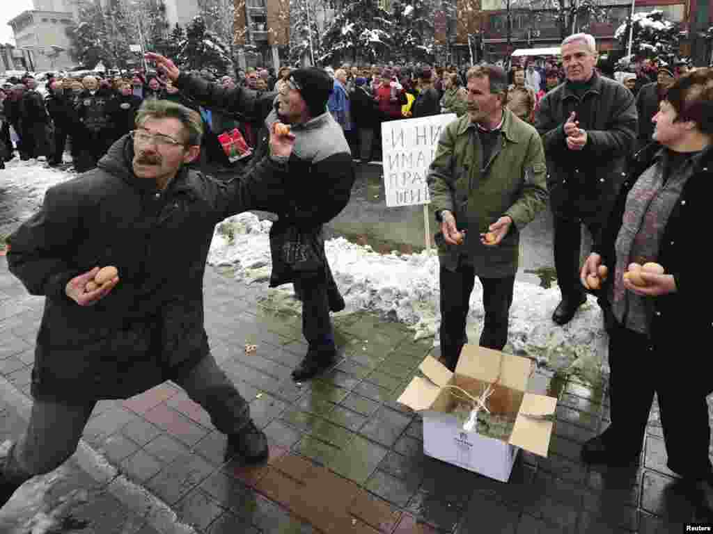 Unemployed workers throw eggs during a protest in front of the government building in Skopje, Macedonia. - The protesters demanded a new law for a retirement plan for laid-off workers who have less than 15 years until retirement, local media reported. Photo by Ognen Teofilovski for Reuters