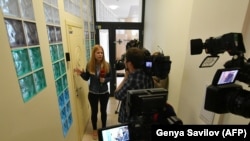 Ukrainian journalists outside the closed door of the Kyiv office of Russia's state-run RIA Novosti news agency on May 15. 