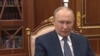 Russian President Vladimir Putin in front of a bookcase in his office in the Kremlin's Senate Palace in Moscow 